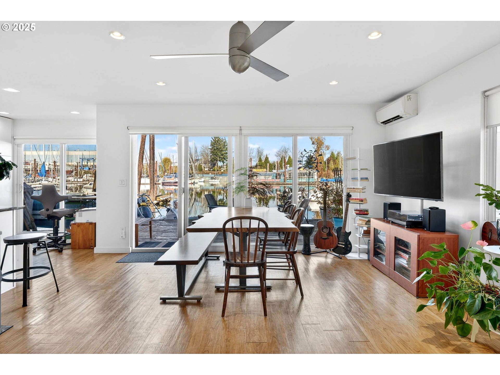 173 Northeast Bridgeton Road, Unit 13 Portland, OR 97211 - Photo 2 of 22 a living room with furniture and a flat screen tv