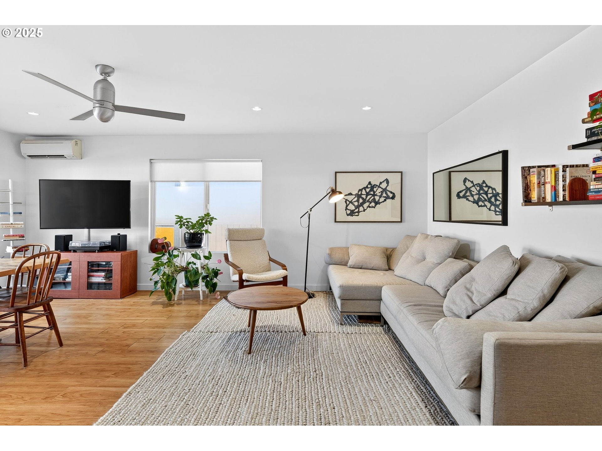 173 Northeast Bridgeton Road, Unit 13 Portland, OR 97211 - Photo 3 of 22 a living room with furniture and a flat screen tv
