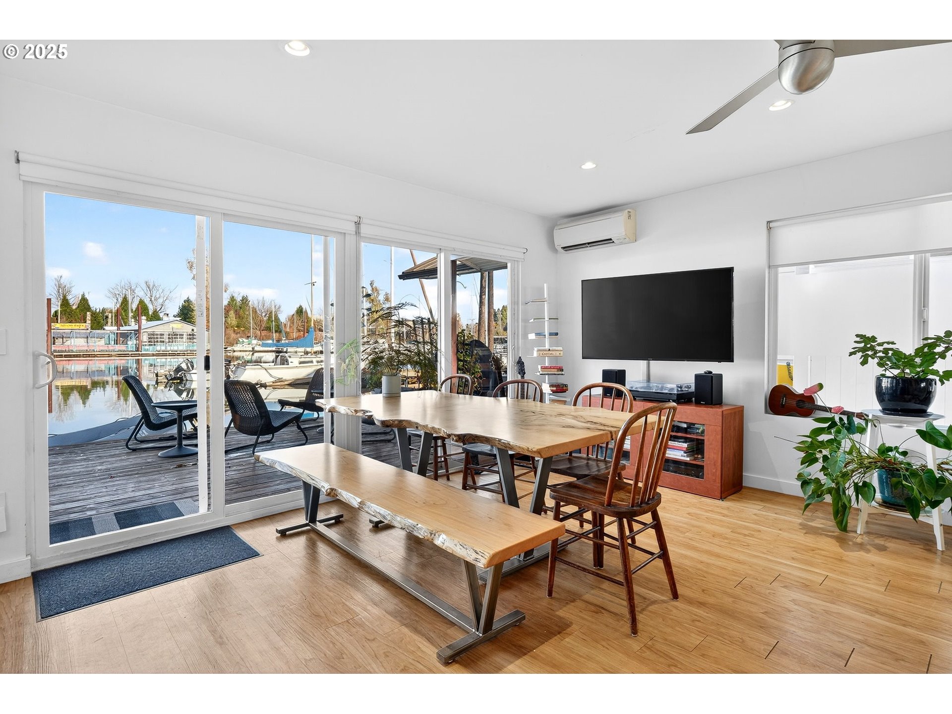 173 Northeast Bridgeton Road, Unit 13 Portland, OR 97211 - Photo 4 of 22 a living room with furniture and a flat screen tv