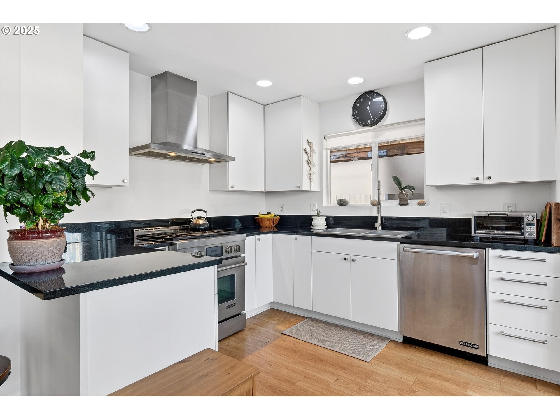 173 Northeast Bridgeton Road, Unit 13 Portland, OR 97211 - Photo 8 of 22 a kitchen with stainless steel appliances granite countertop a sink a stove a microwave a sink and cabinets