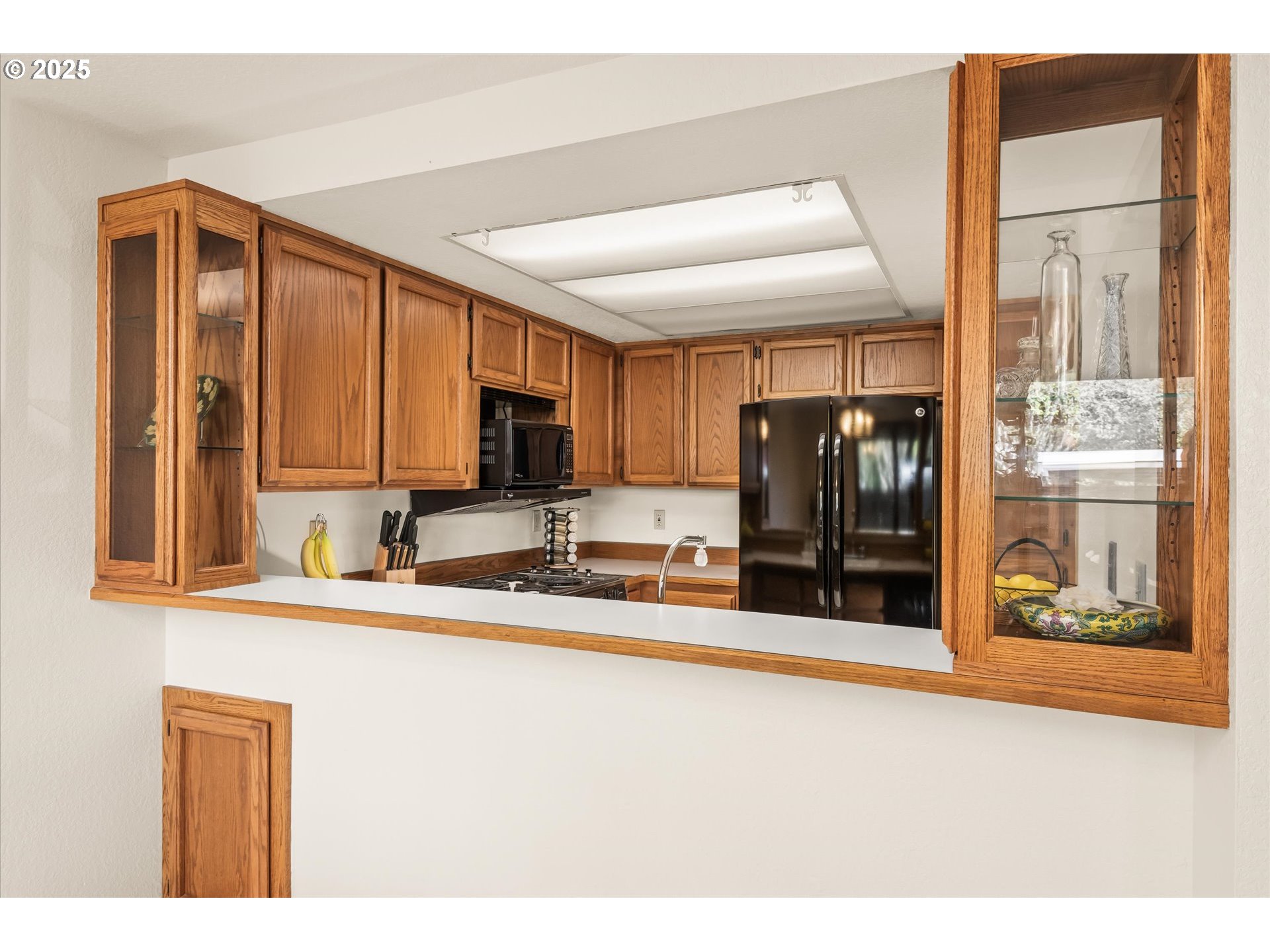 2095 Lake Isle Drive Eugene, OR 97401 - Photo 11 of 32 a kitchen with stainless steel appliances a sink and a refrigerator