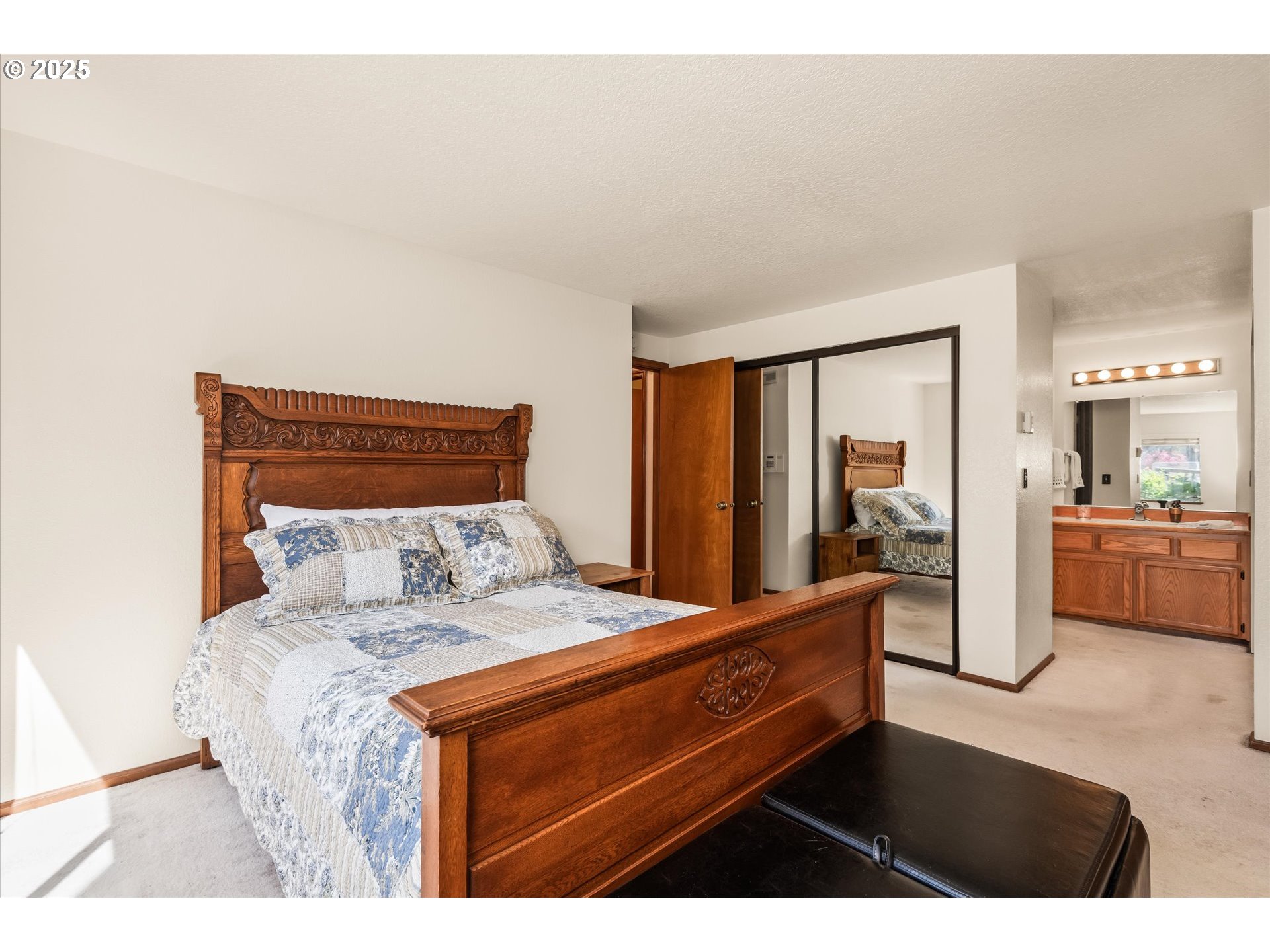 2095 Lake Isle Drive Eugene, OR 97401 - Photo 16 of 32 a bedroom with a bed and a large mirror