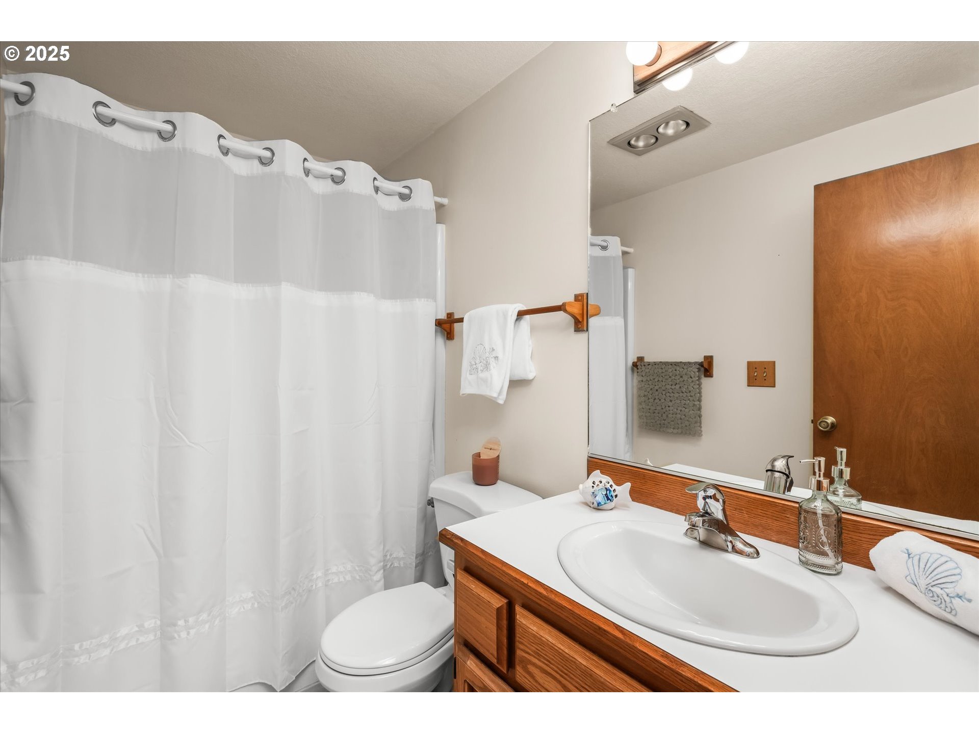 2095 Lake Isle Drive Eugene, OR 97401 - Photo 22 of 32 a bathroom with a sink vanity mirror and toilet