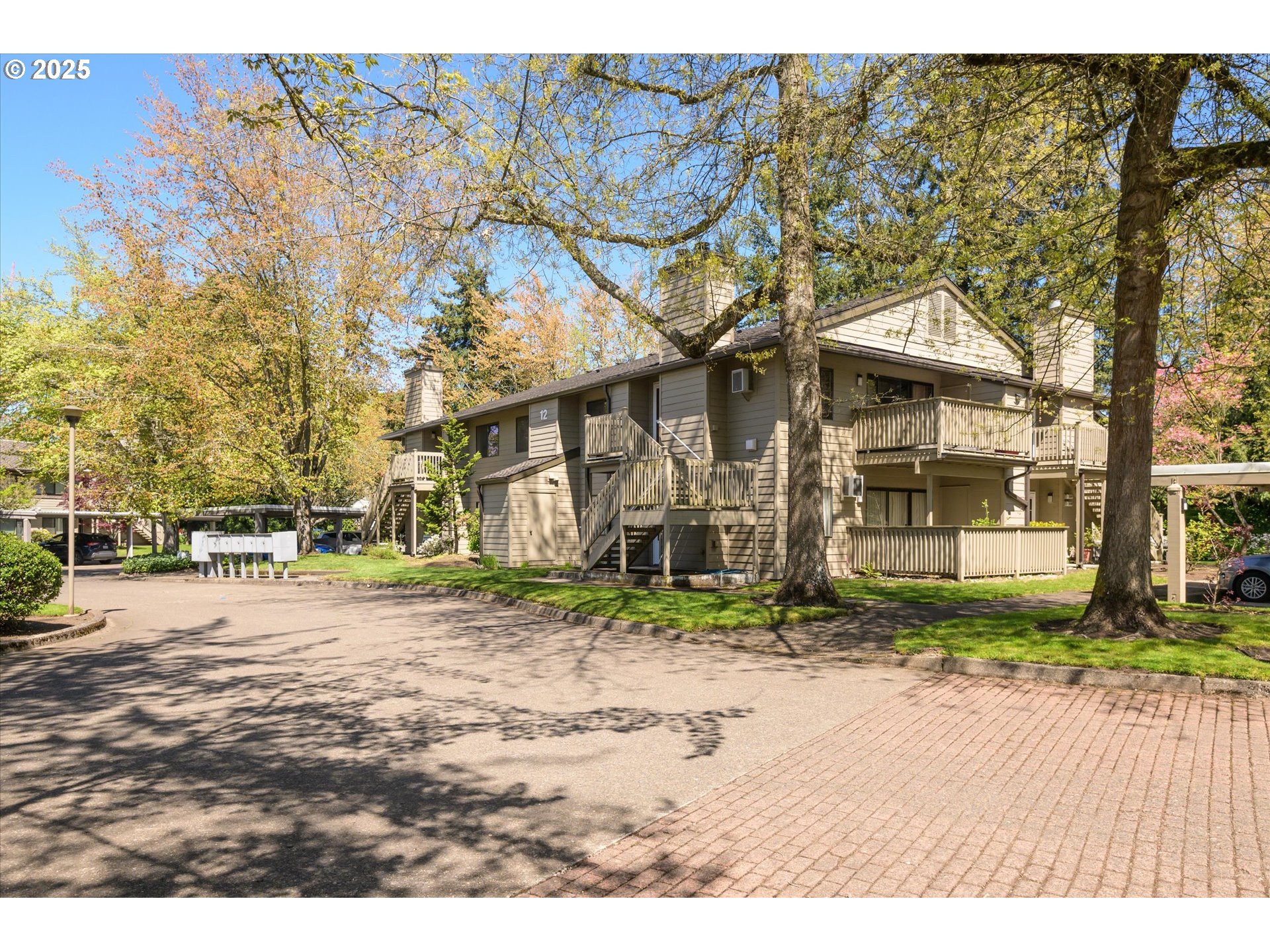 2095 Lake Isle Drive Eugene, OR 97401 - Photo 29 of 32 a backyard of a house with large trees and a wooden fence
