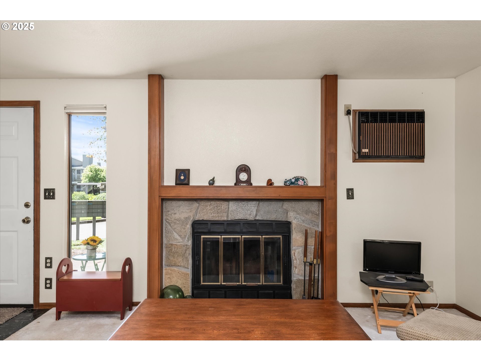 2095 Lake Isle Drive Eugene, OR 97401 - Photo 7 of 32 a living room with furniture a flat screen tv and a fireplace