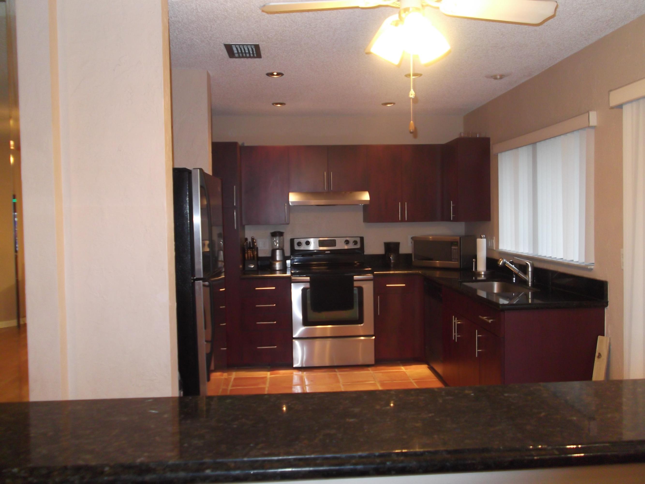 9665 Golf State Park Way Boca Raton, FL 33428 - Photo 15 of 22 a kitchen with a sink and cabinets
