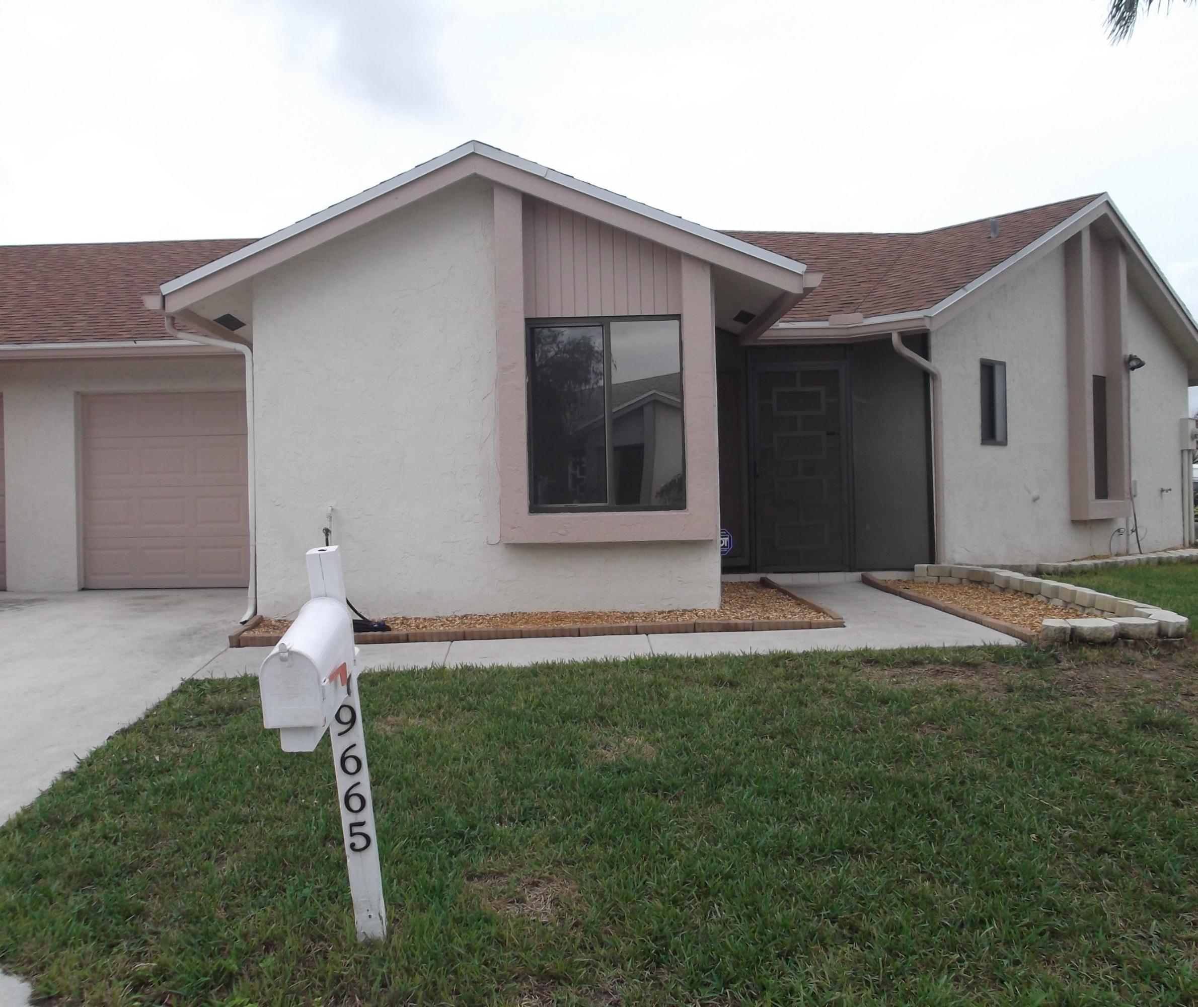 9665 Golf State Park Way Boca Raton, FL 33428 - Photo 22 of 22 a front view of a house with a yard and garage