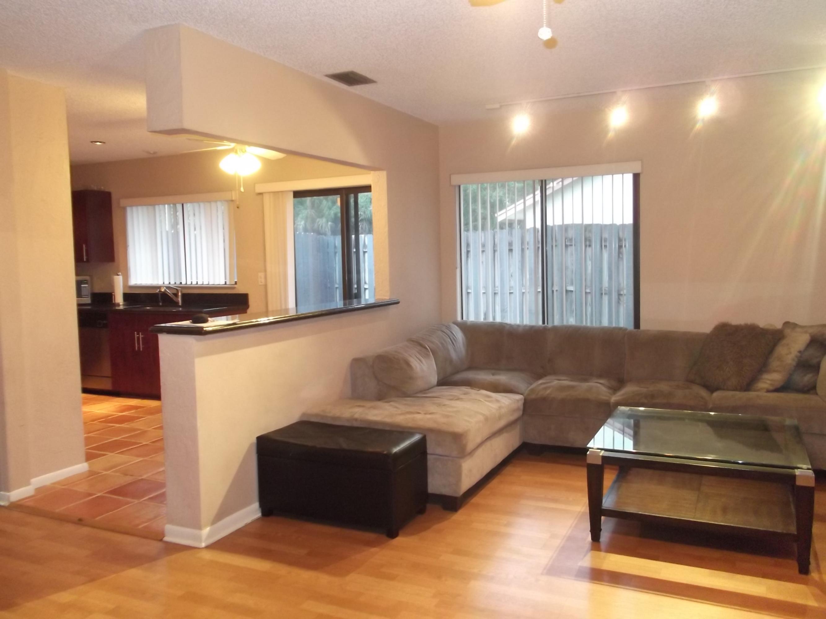 9665 Golf State Park Way Boca Raton, FL 33428 - Photo 4 of 22 a living room with furniture and large windows