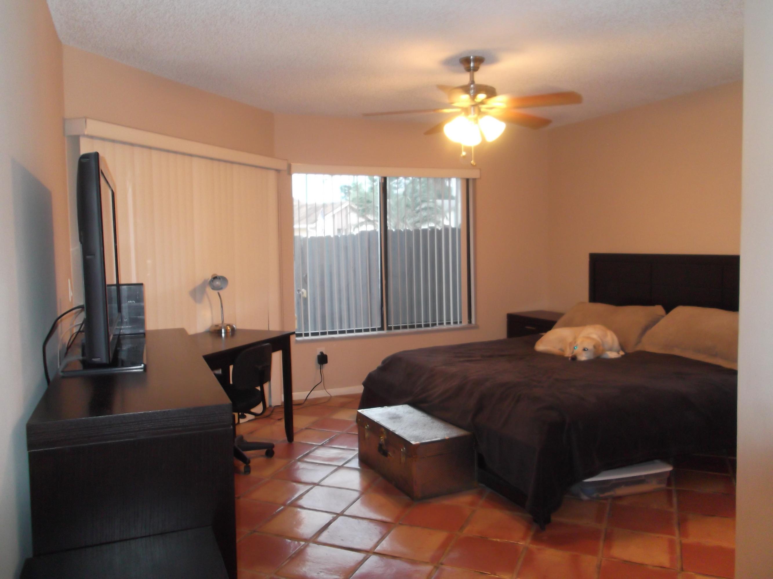 9665 Golf State Park Way Boca Raton, FL 33428 - Photo 7 of 22 a bedroom with a bed and a chandelier