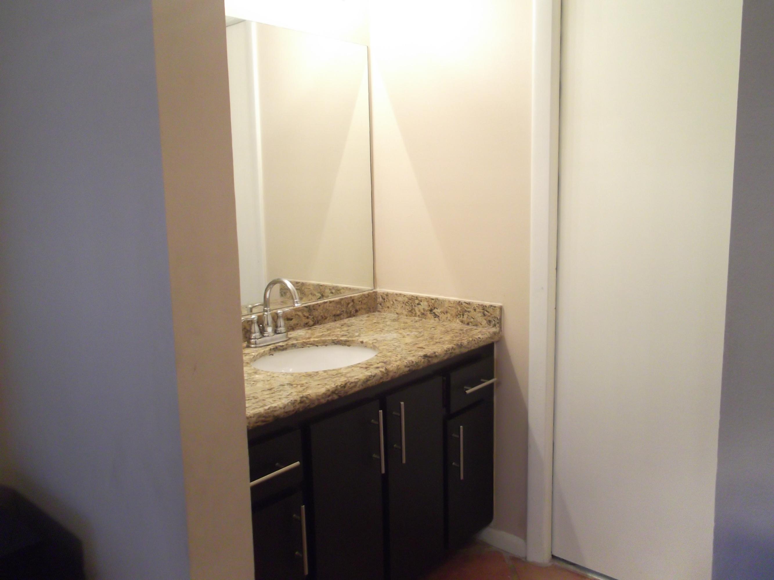9665 Golf State Park Way Boca Raton, FL 33428 - Photo 9 of 22 a bathroom with a granite countertop sink and a mirror