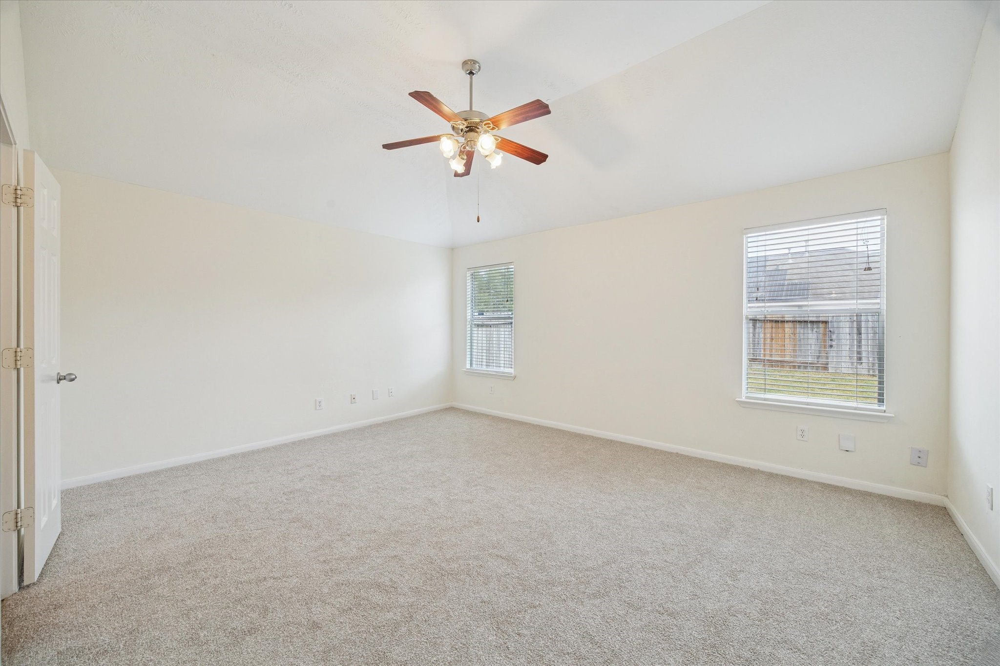 14102 Kinsbourne Lane Houston, TX 77014 - Photo 5 of 13 Just off the den is the spacious primary bedroom with new carpet and pad, and lighted ceiling fan.