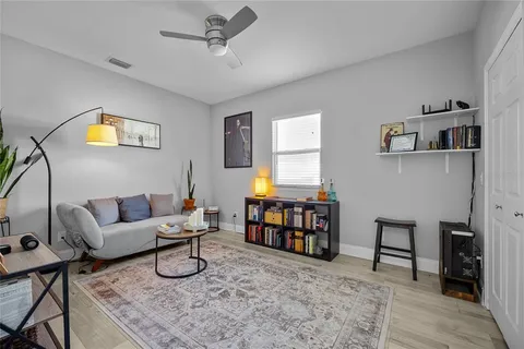 a living room with furniture and a wooden floor