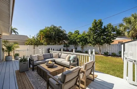 a terrace with outdoor seating and wooden floor