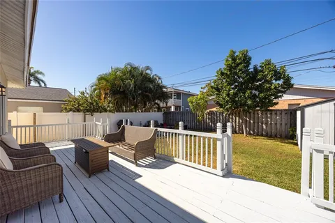a view of a deck with couches with wooden floor and fence