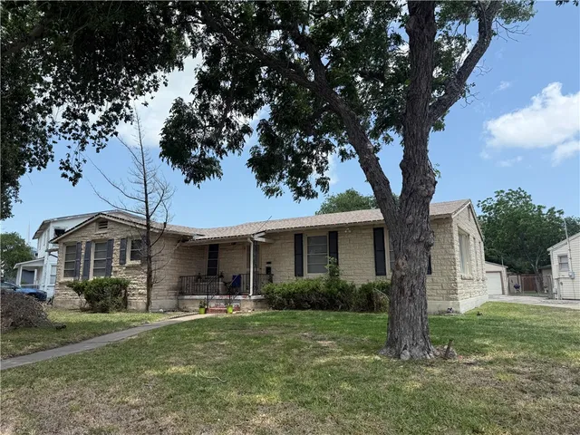 a front view of house with yard and green space