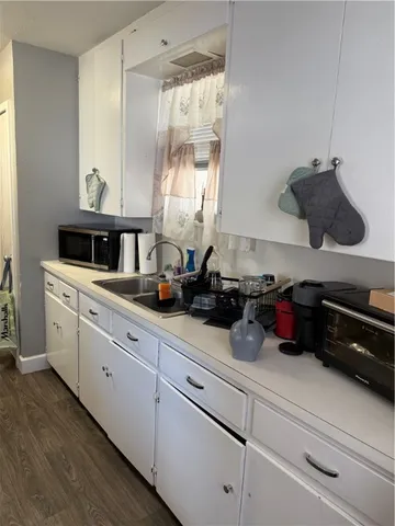 a kitchen with white cabinets and a sink
