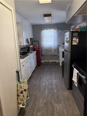 a kitchen with stainless steel appliances a stove a refrigerator and a sink