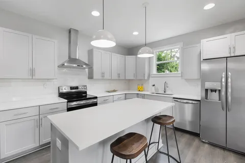 a kitchen with a stove a refrigerator and a sink