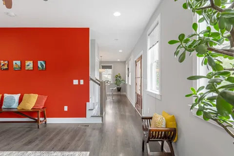 a view of a livingroom with furniture and a potted plant