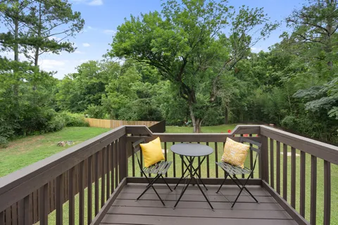 a view of a chair and table on the deck