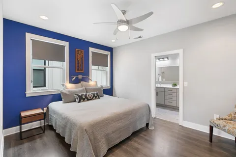 a bedroom with a bed and a potted plant