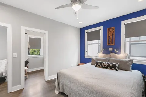 a bedroom with a large bed and a window