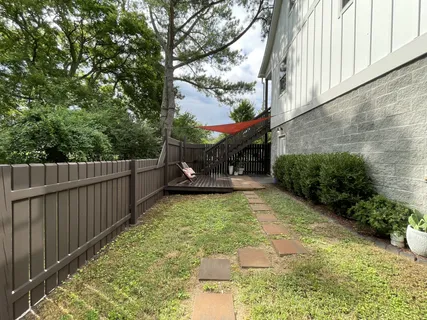 a view of a yard with large trees