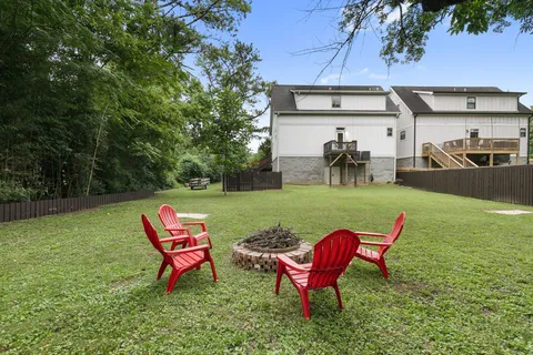 a view of a yard with furniture and a garden