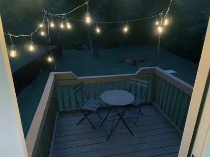 a backyard of a house with table and chairs