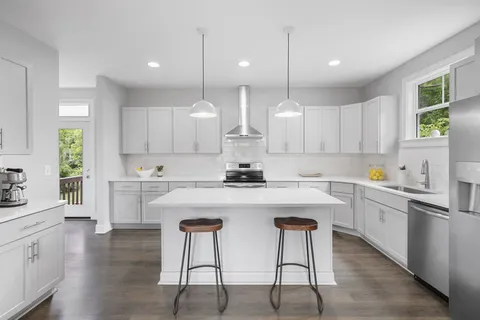 a kitchen with white cabinets and white appliances