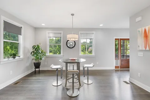 a view of a dining room with furniture window and wooden floor