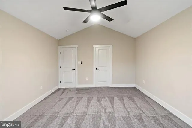 a view of an empty room with a ceiling fan