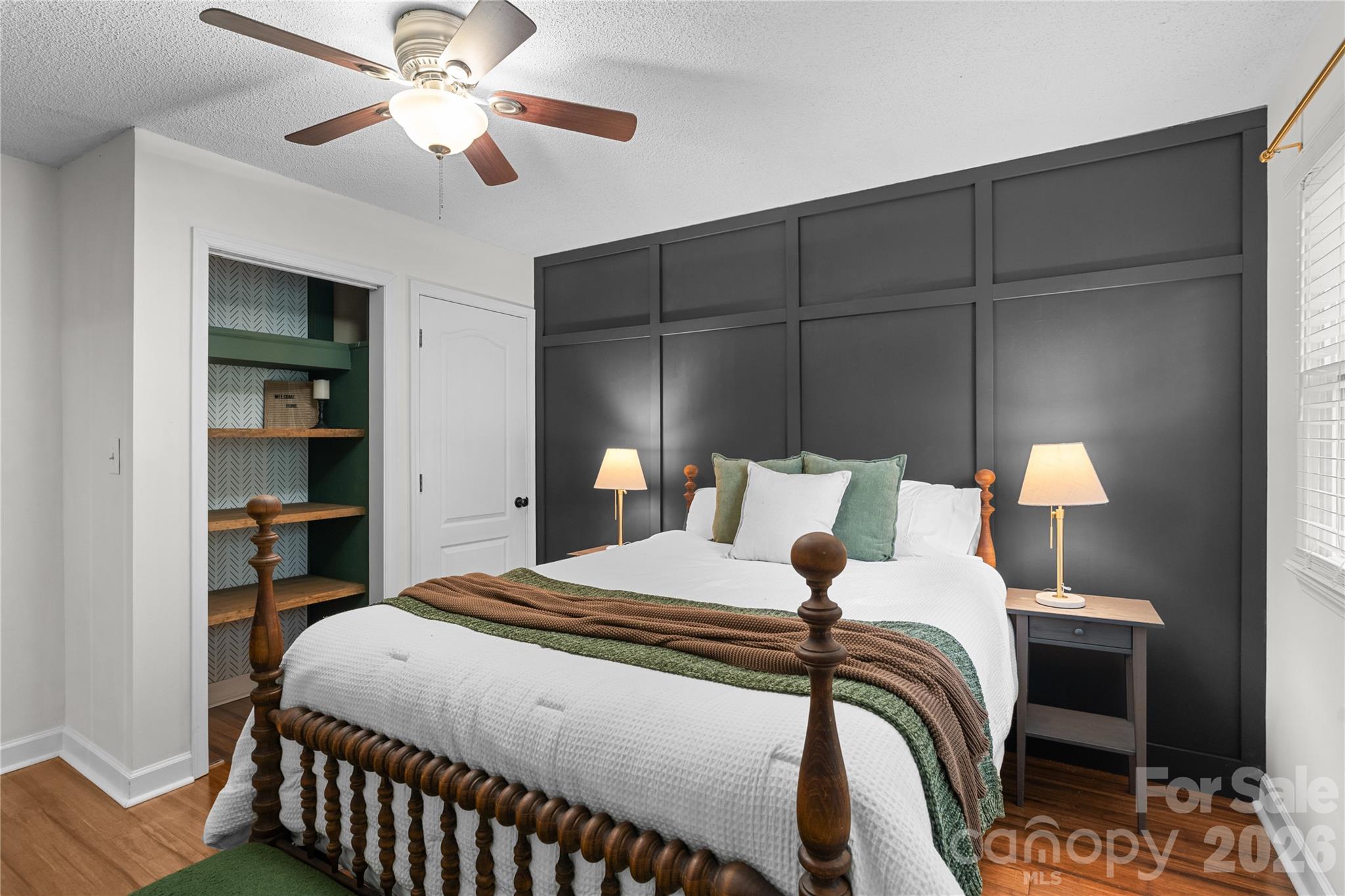 1335 Blacksnake Road Stanley, NC 28164 - Photo 23 of 31 a bedroom with a bed and a chandelier