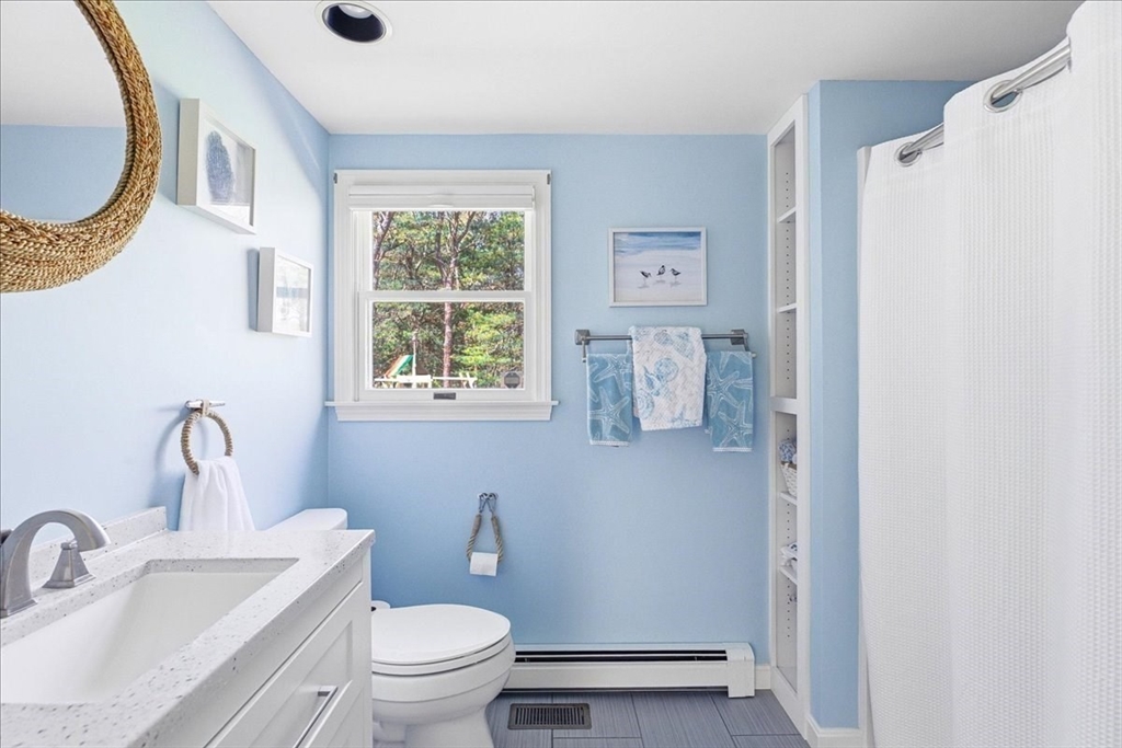 12 Salt Marsh Lane Wareham, MA 02571 - Photo 18 of 41 a bathroom with a toilet sink a mirror and a window