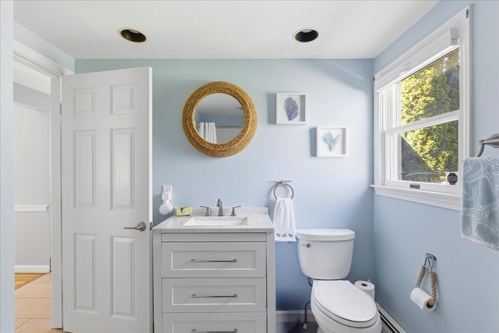 12 Salt Marsh Lane Wareham, MA 02571 - Photo 19 of 41 a bathroom with a toilet a sink a mirror and a window