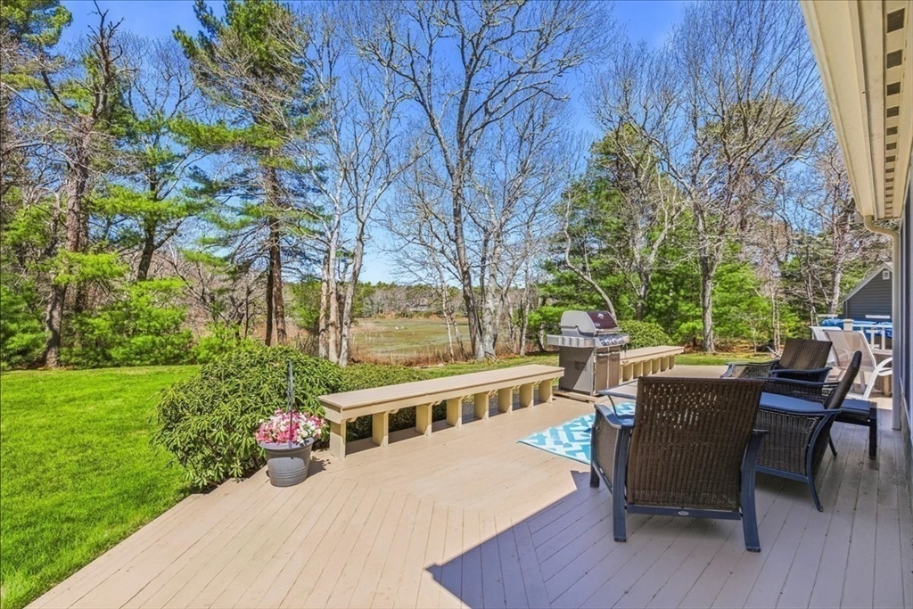 12 Salt Marsh Lane Wareham, MA 02571 - Photo 31 of 41 a view of a chairs and table in backyard of the house