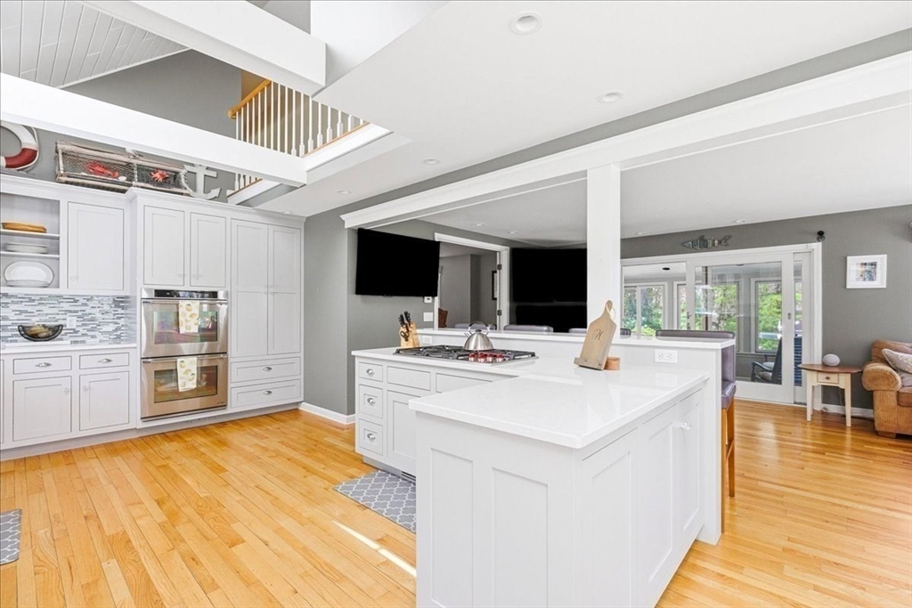12 Salt Marsh Lane Wareham, MA 02571 - Photo 9 of 41 a open kitchen with stainless steel appliances kitchen island granite countertop a stove and a view of living room