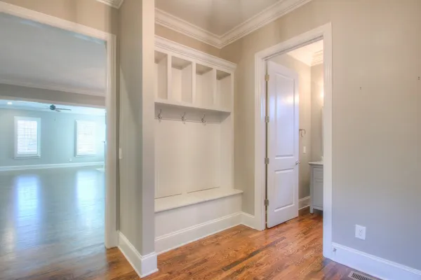 a view of empty room with wooden floor