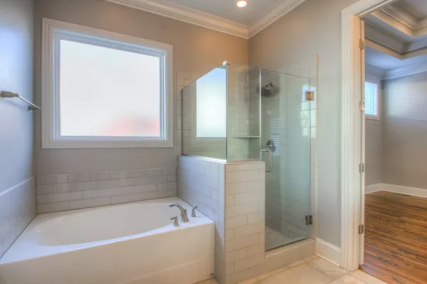a bathroom with a bathtub shower and toilet