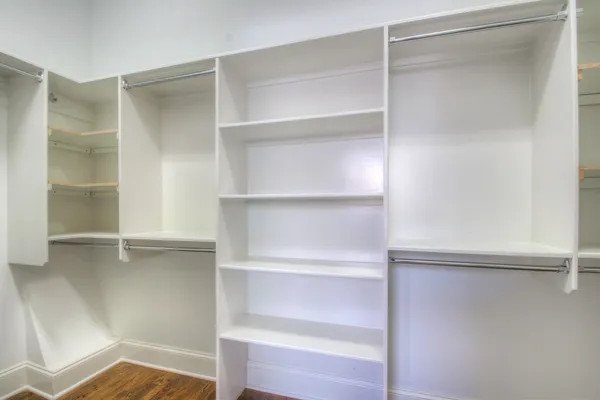 a view of walk in closet with empty racks
