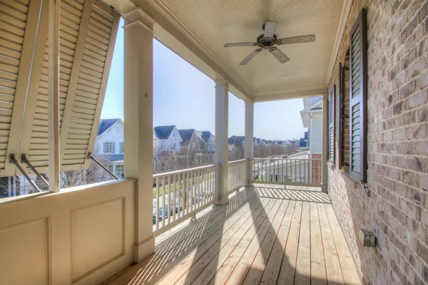 a view of a balcony with a floor to ceiling window with wooden floor