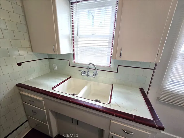 a view of kitchen with a sink and wooden floor