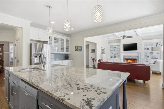 a kitchen with stainless steel appliances granite countertop a sink stove and cabinets