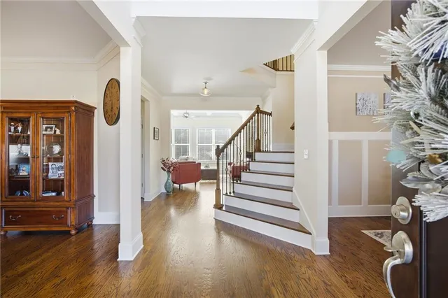 a view of an entryway with wooden floor and stairs