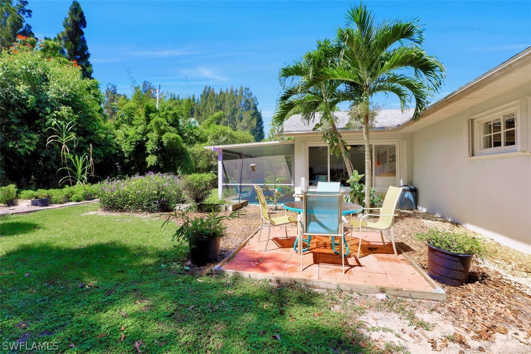 5807 Tarpon Road Bokeelia, FL 33922 - Photo 4 of 25 a view of a backyard with plants and a patio