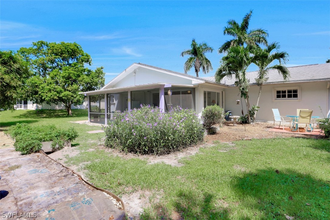 5807 Tarpon Road Bokeelia, FL 33922 - Photo 5 of 25 a front view of a house with a garden