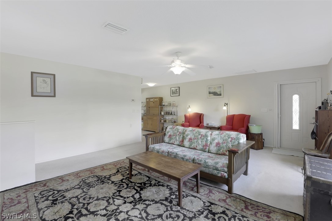 5807 Tarpon Road Bokeelia, FL 33922 - Photo 8 of 25 a living room with furniture and a rug