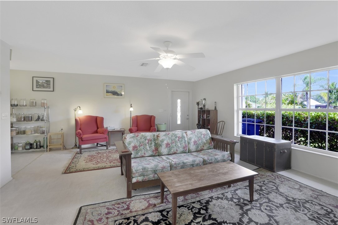 5807 Tarpon Road Bokeelia, FL 33922 - Photo 9 of 25 a living room with furniture and a window