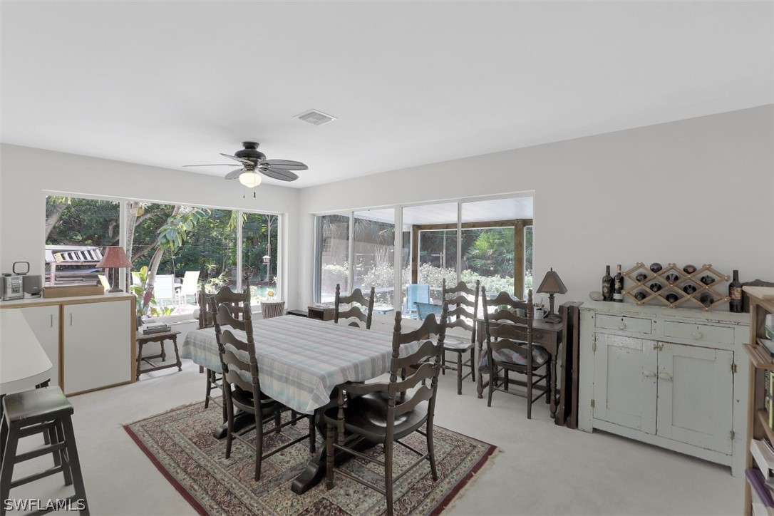 5807 Tarpon Road Bokeelia, FL 33922 - Photo 10 of 25 a view of a dining room with furniture window and outside view