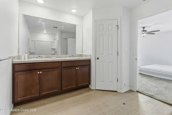 a spacious bathroom with a granite countertop sink and a mirror